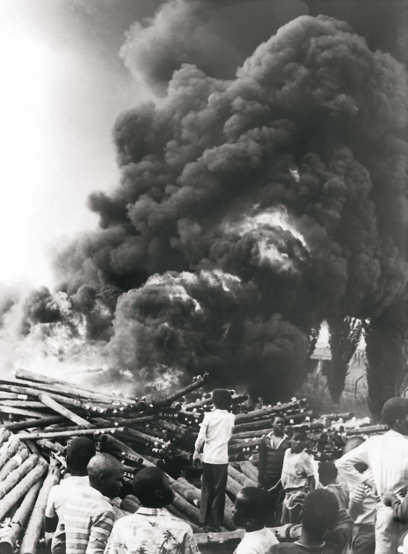Children look on as Khwezi Station, Soweto, goes up in smoke.